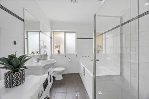 a bathroom with a toilet sink and a shower at Sunset Seas in West Beach in West Beach +30 photos