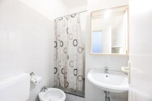 a bathroom with a sink and a toilet and a mirror at Hotel Le Ghiaie in Portoferraio +57 photos