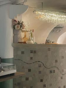 a kitchen with a counter top with a flowered at Hôtel CASITA in Puygiron