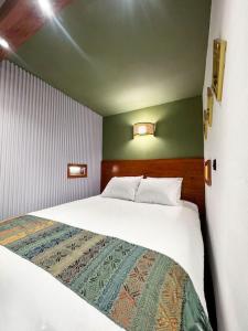 a bedroom with a large white bed in a room at Toliman Room in San Lucas Tolimán