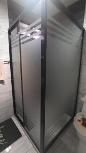 a glass shower door in a bathroom with a toilet at Casa Terraza Oaxaca in San Sebastián Etla +11 photos