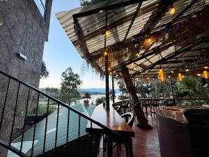 a balcony of a restaurant with a view of a river at Garden Gathering Room in San Lucas Tolimán