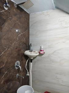 a bathroom with a sink and a toilet at Shiv Lehri Homestay in Ujjain