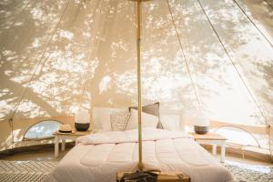 a bedroom with a bed in a tent at Odyssey Eco Farm Glamping in Galatas