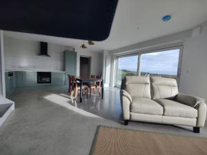 a living room with a couch and a table at Lighthouse view in Garryvoe