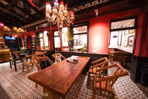 a dining room with a wooden table and chairs at POSHPACKER - Chengdu Mix Hostel - Cicada Zen Yard in Chengdu