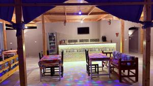 a room with a table and chairs and a fireplace at Magic Garden House in Luxor