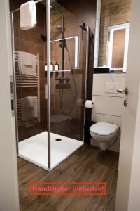 a bathroom with a shower and a toilet at Red Kite Resort in Ribnitz-Damgarten +21 photos