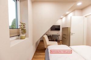 a small room with a bed and a table at Red Kite Resort in Ribnitz-Damgarten