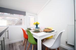 a dining room with a white table and chairs at Afan House by STAE-Homes in Glyncorrwg +31 photos