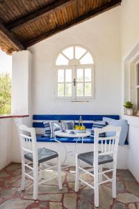 a table and chairs in a room with a window at Odyssey Eco Farm Glamping in Galatas +24 photos