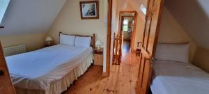 a bedroom with two beds in a attic at Moulamill Cottage Bed and Breakfast Glenlough P75RY86 in Ahakista