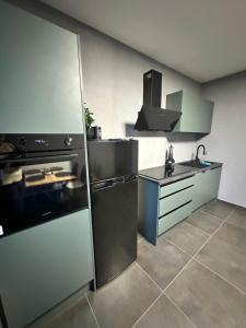a kitchen with stainless steel appliances and a stove at STAYtion Ferienhaus Balingen in Balingen