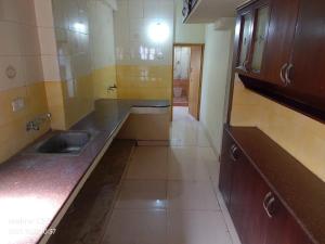 a kitchen with a sink and a counter top at Hotel Raaj Inn Service Apartment in Chennai +23 photos