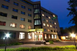 a building with a hotel sign in front of it at Ural Hotel in Yekaterinburg