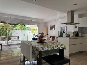 a kitchen with a table with a table cloth on it at Spacious open plan ground floor apartment in Port de Pollensa