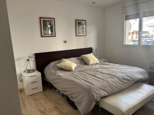 a bed with two pillows on it in a bedroom at Spacious open plan ground floor apartment in Port de Pollensa