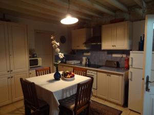 a kitchen with a table with a bowl of fruit on it at Oinochori in Vouni