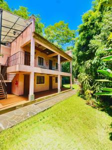 an exterior view of a house with a yard at Rincón Escondido B&B in Puerto Iguazú