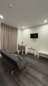 a living room with a couch and a tv at Gold Center Funchal 101 in Funchal