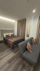 a bedroom with a bed and a couch at Gold Center Funchal 101 in Funchal +33 photos