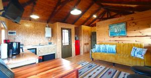 a living room with a couch and a kitchen at 7 on Kloof in Mossel Bay
