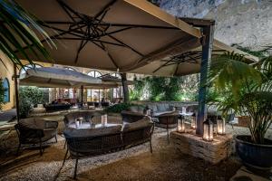 a patio with tables and umbrellas in a restaurant at Il Rivalta - Place of Charme in Florence
