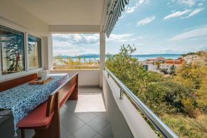 a balcony with a table and a view of the ocean at Apartment Bernarda in Igrane