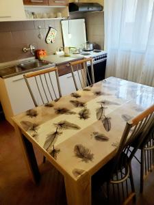 a kitchen with a wooden table with leaves on it at Apartment PER DAY in Vrbas