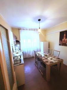 a kitchen and dining room with a table and chairs at Apartment PER DAY in Vrbas