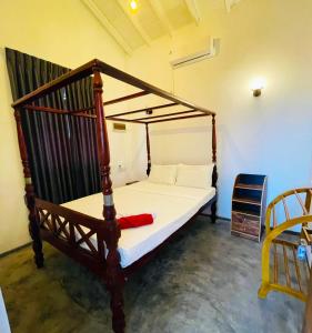 a bedroom with a bed with a wooden frame at Palms and Paradise Lanka in Marawila