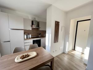 a kitchen and dining room with a wooden table at Mono Giudici in Clusone +1 photo