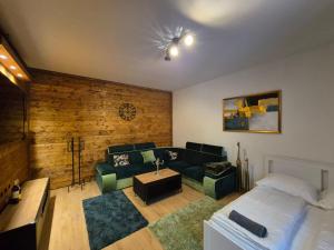 a living room with a bed and a couch at JÓKAI Apartman in Komárno