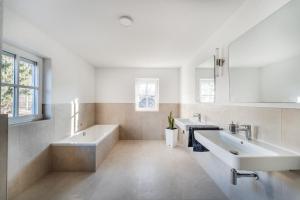 a bathroom with two sinks and a large mirror at Check-In by BeOne RW-N in Rottweil +62 photos