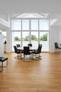 a dining room with a table and chairs at Villa Silbermöwe in Trent +24 photos