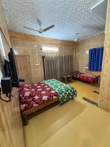 a bedroom with a bed and a tv in it at Happy Hills in Yelagiri