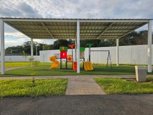 a park with a playground with a play equipment at Casa Márquez in San Miguel