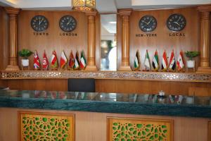 a lobby with clocks on the wall and a counter at Hotel karim Tunis in Tunis