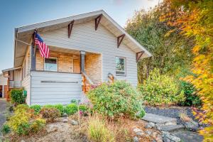 a house with a garage and an american flag on it at La Maison - Elegant 2BR Escape - Free Breakfast! in Albany