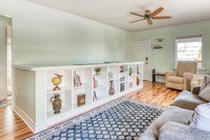 a living room with a couch and a ceiling fan at La Maison - Elegant 2BR Escape - Free Breakfast! in Albany