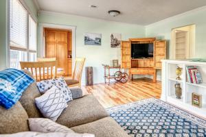 a living room with a couch and a television at La Maison - Elegant 2BR Escape - Free Breakfast! in Albany