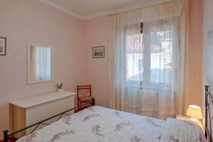 a bedroom with a bed and a window at Casa Niky in Verbania