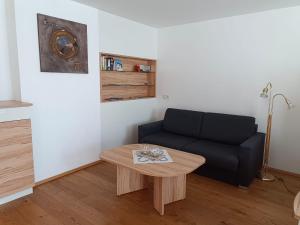 a living room with a couch and a table at Penthaus Appartement in Sankt Michael im Lungau