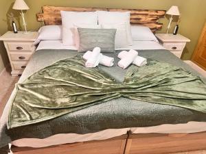 a bed with two towels and two pillows on it at Casa Rural La Joya in Candeleda +47 photos