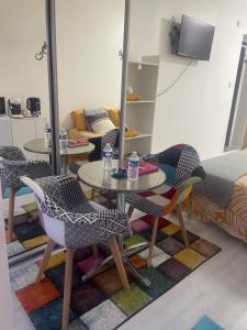 a living room with a table and chairs and a couch at Chez Fabrice in Lunel