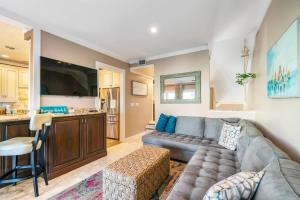 a living room with a couch and a kitchen at Sunkissed Oasis in Navarre