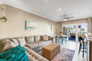 a living room with a couch and a table at Sunkissed Oasis in Navarre