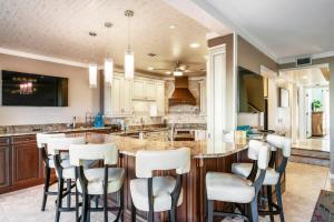 a kitchen with a large island with bar stools at Sunkissed Oasis in Navarre +50 photos
