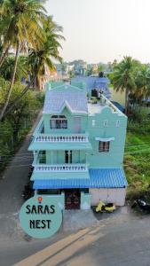 a blue house with a sams nest sign in front of it at Le Sara's Nest in Pondicherry