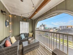 a balcony with two couches and a view of a city at Sea The Good condo in Carolina Beach +24 photos